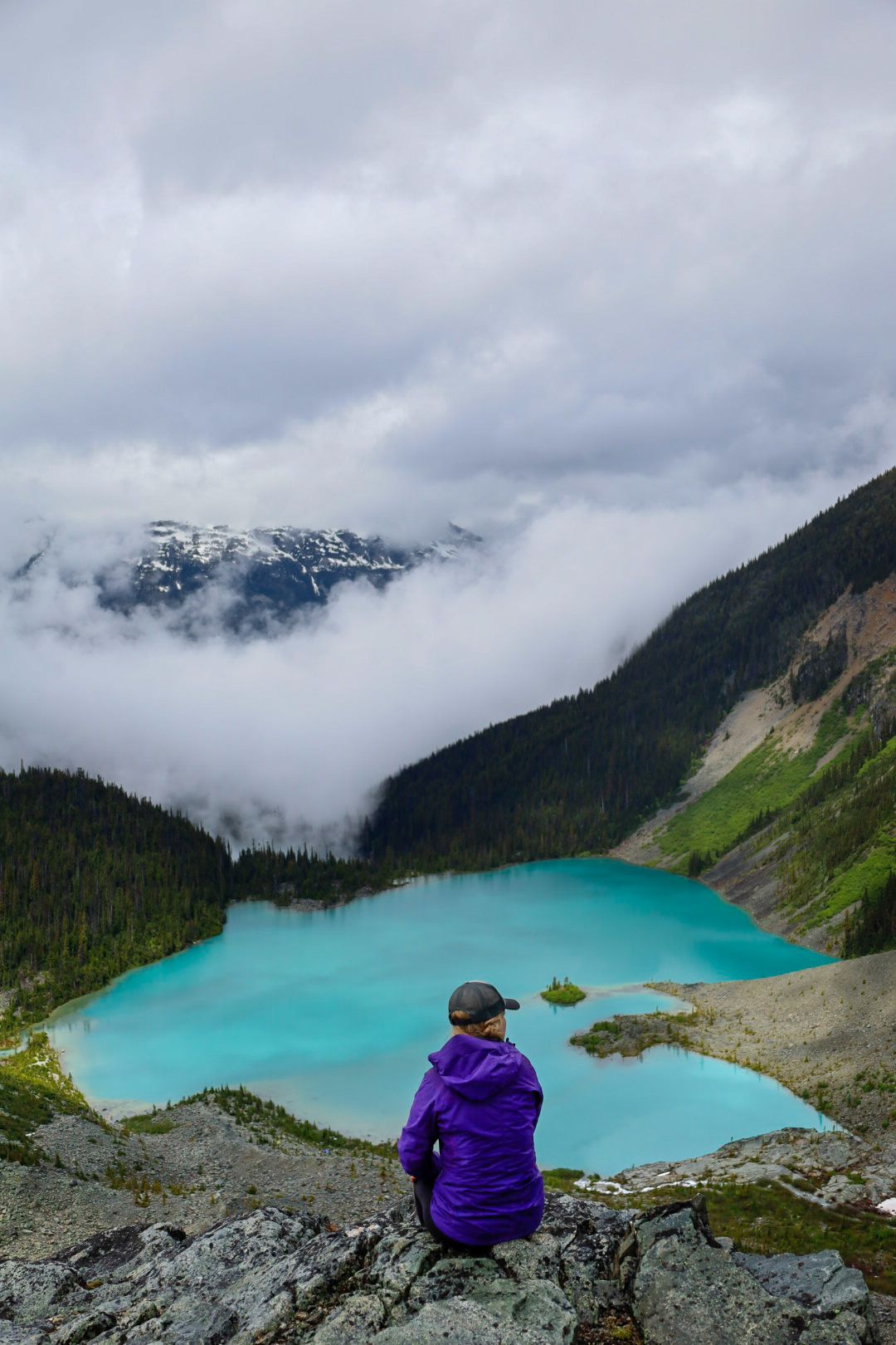 women overlooking a glacier fed lake in the mountains