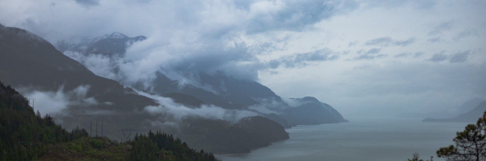 Very cloudy, moody canadian west coast mountain fjord